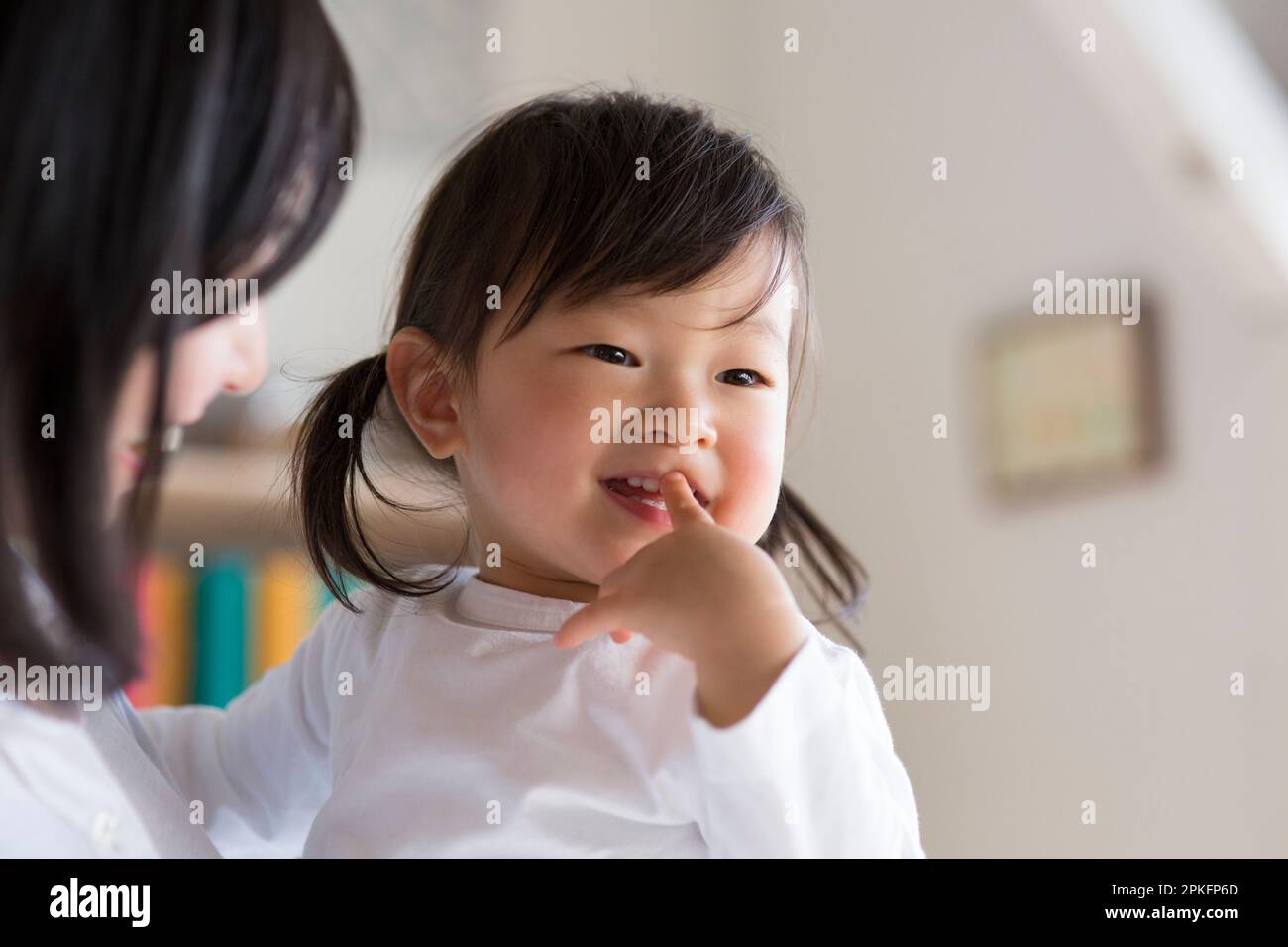 Child being held by mother Stock Photo Alamy