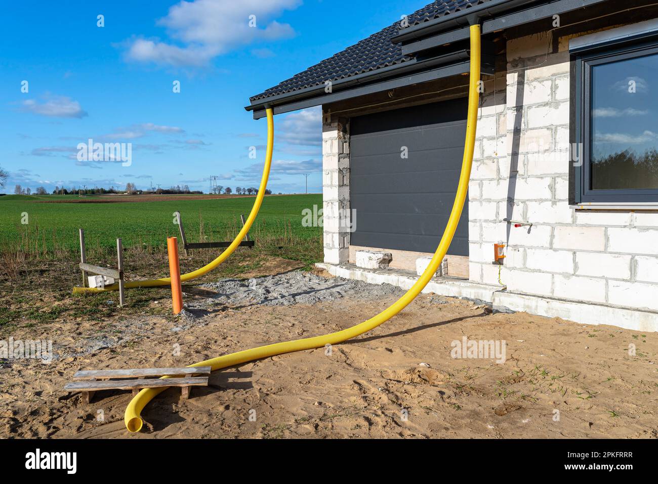 100mm diameter yellow PVC pipe connected to the end of the gutter on