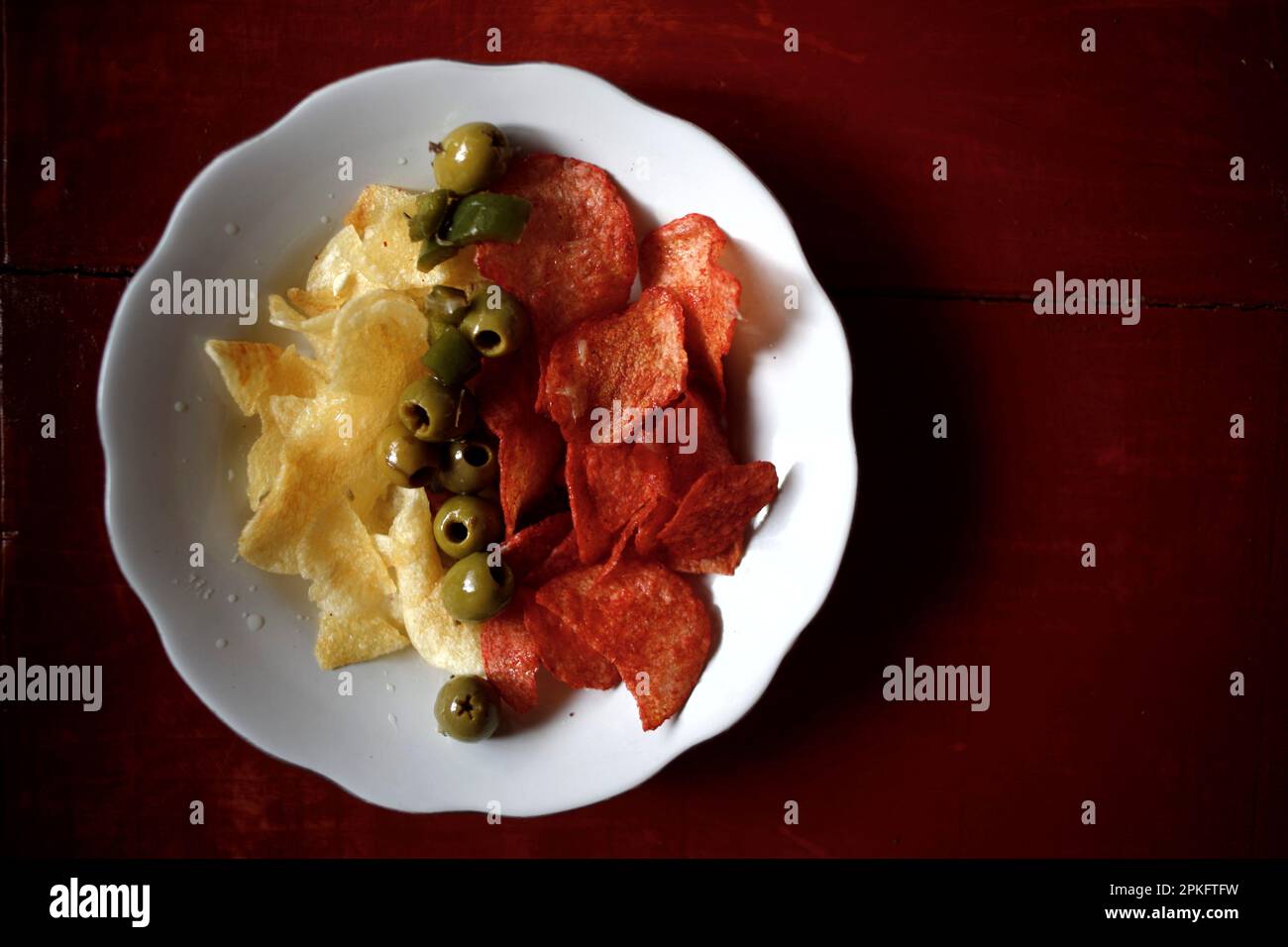 A plate with fried potato chips and fried potato chips with red hot chili  chipotle and olives in the middle in a kitchen in Queretaro, Mexico Stock  Photo - Alamy