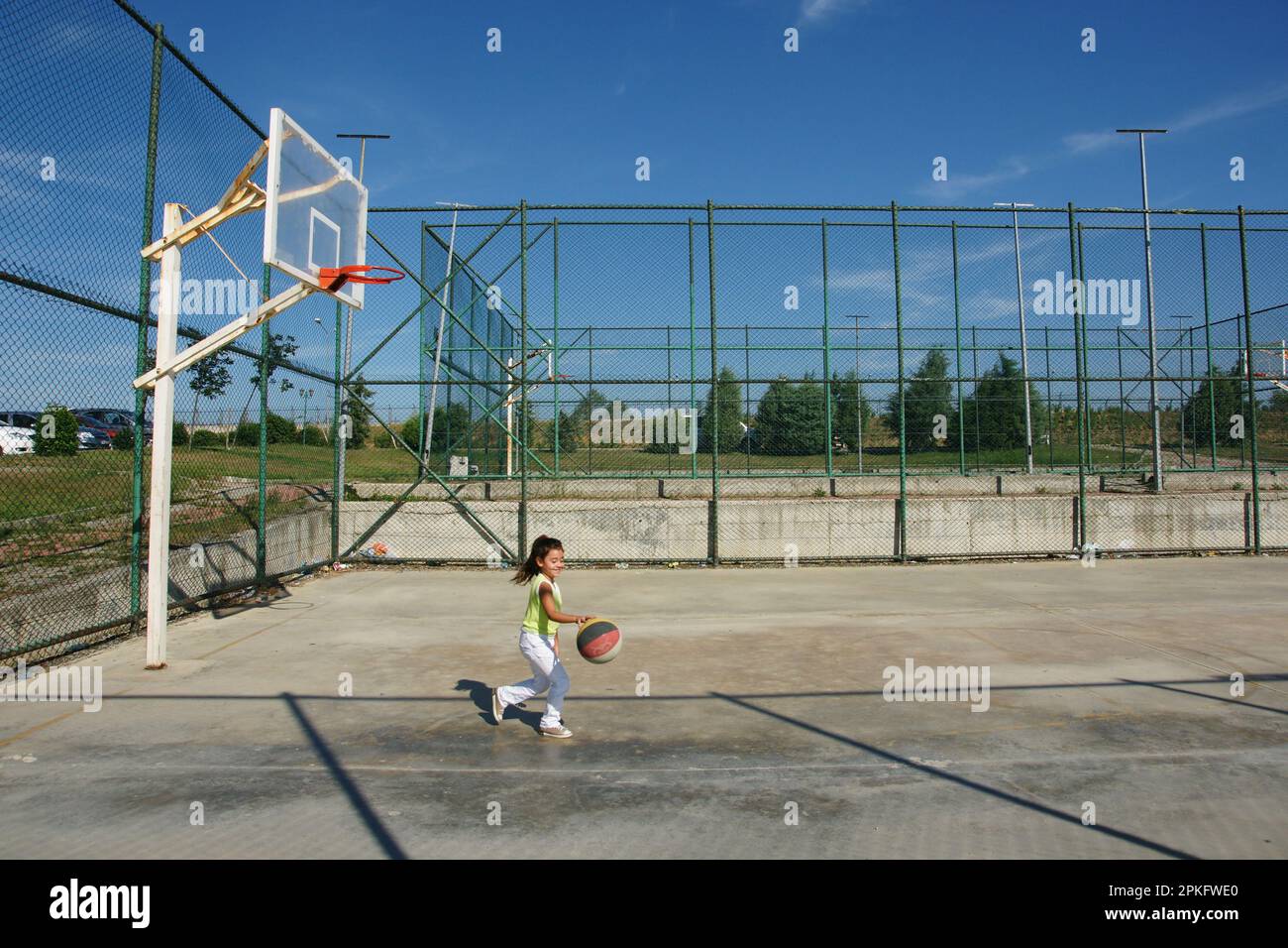 Boy and his brother playing on the basketball court Stock Photo Alamy