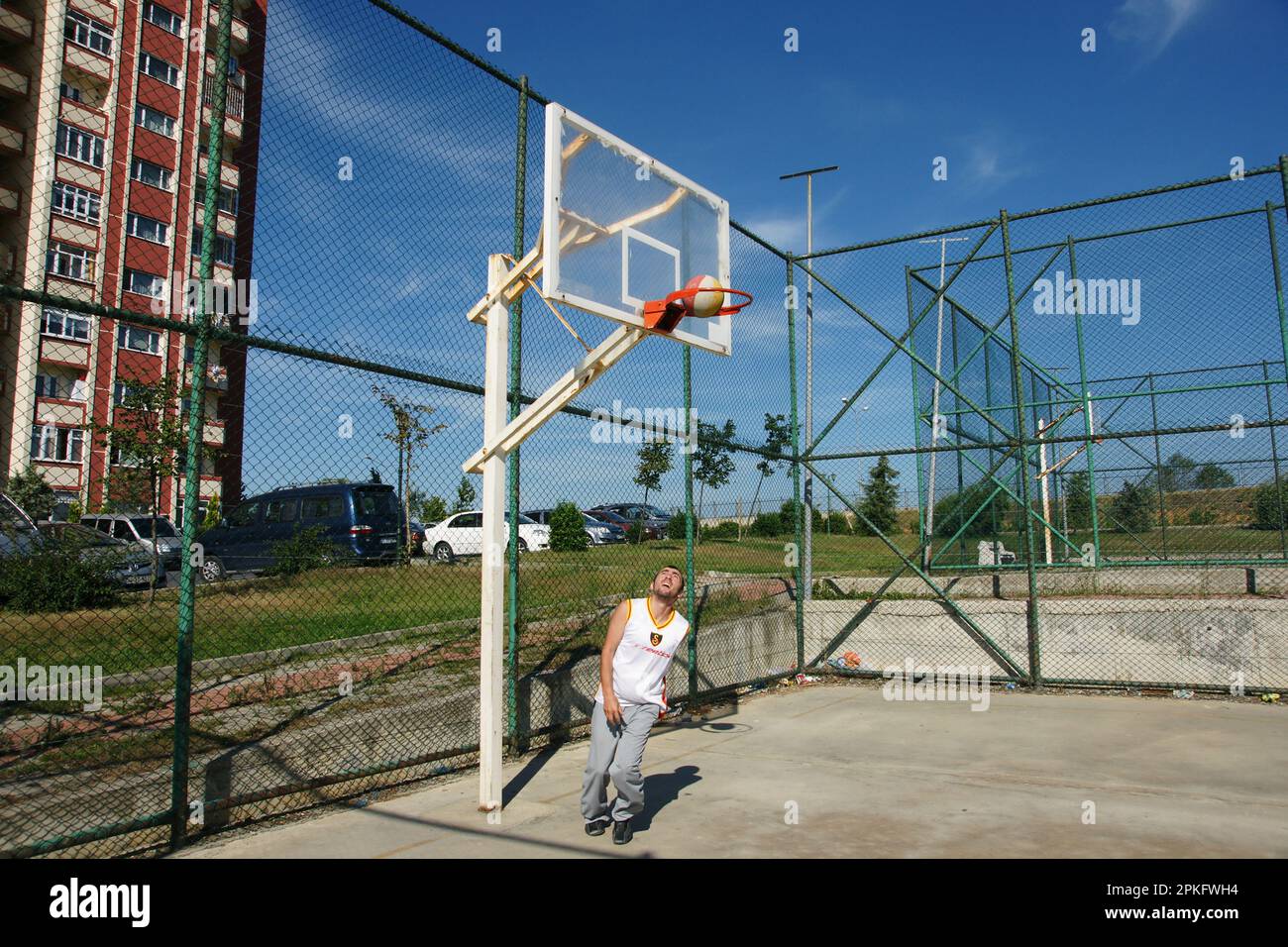 Boy and his brother playing on the basketball court Stock Photo Alamy