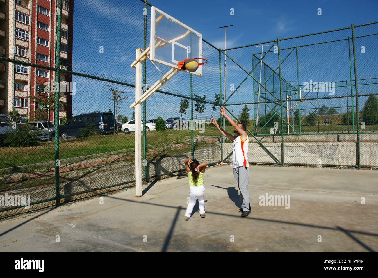 Boy and his brother playing on the basketball court Stock Photo Alamy