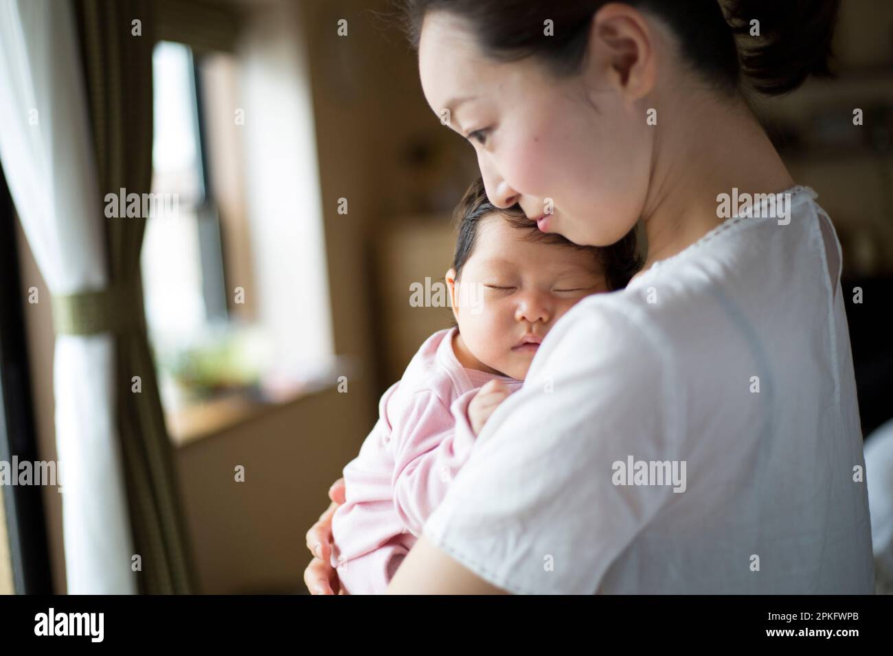 Baby sleeping in mother's arms Stock Photo Alamy