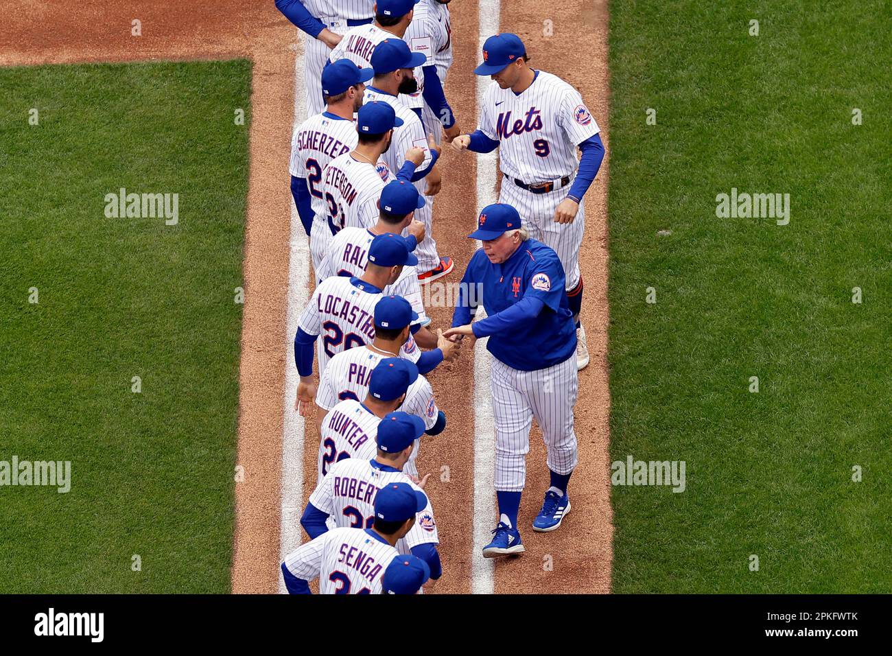 New York Mets manager Buck Showalter shakes hands with players before