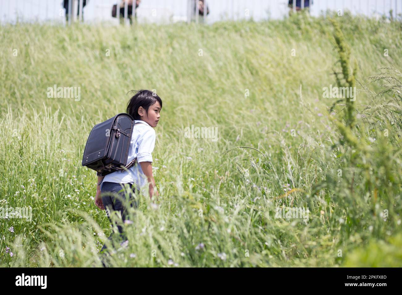 Boy walking with school bag on his back Stock Photo - Alamy