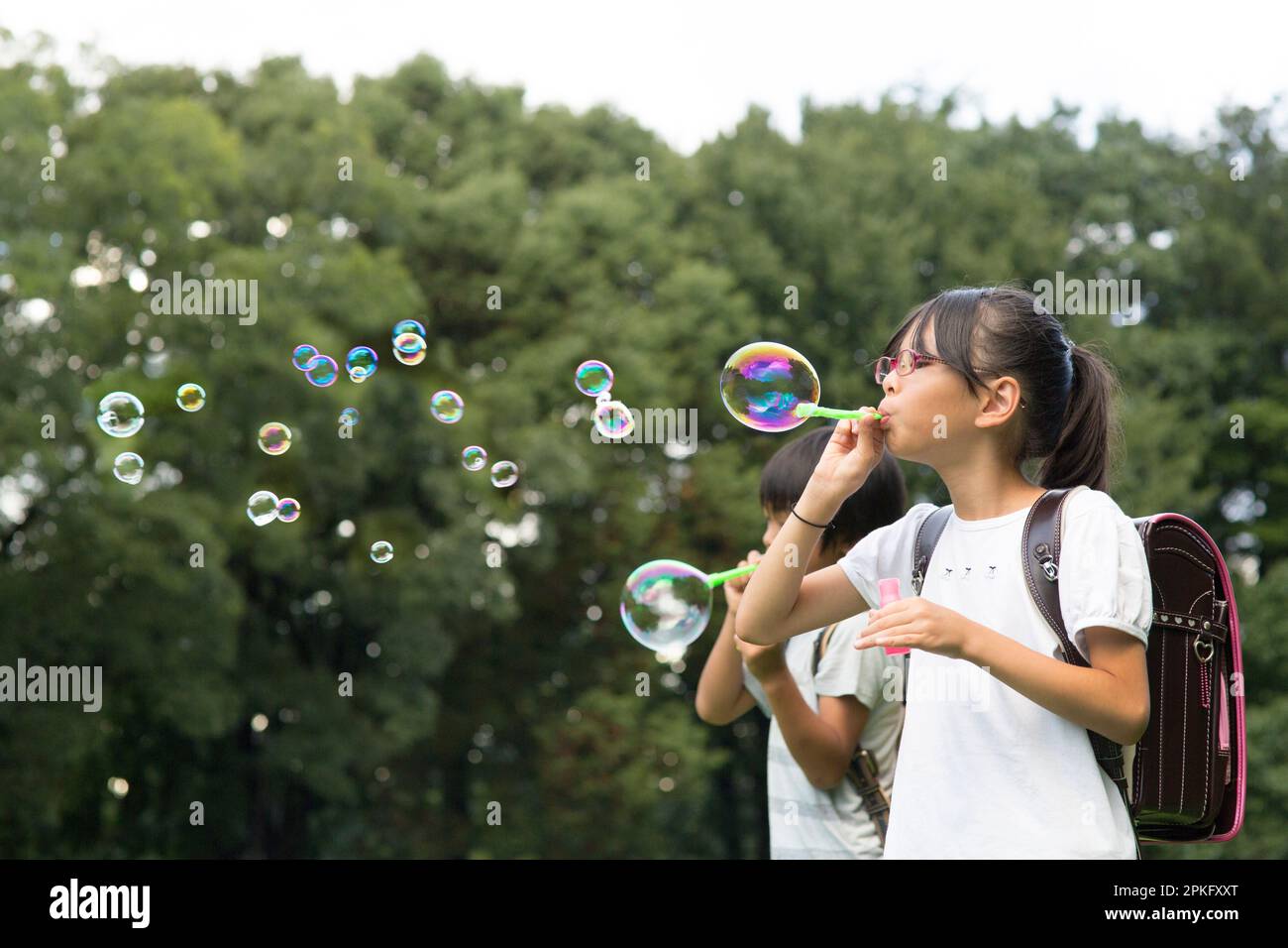 Elementary school child playing with soap bubbles Stock Photo Alamy