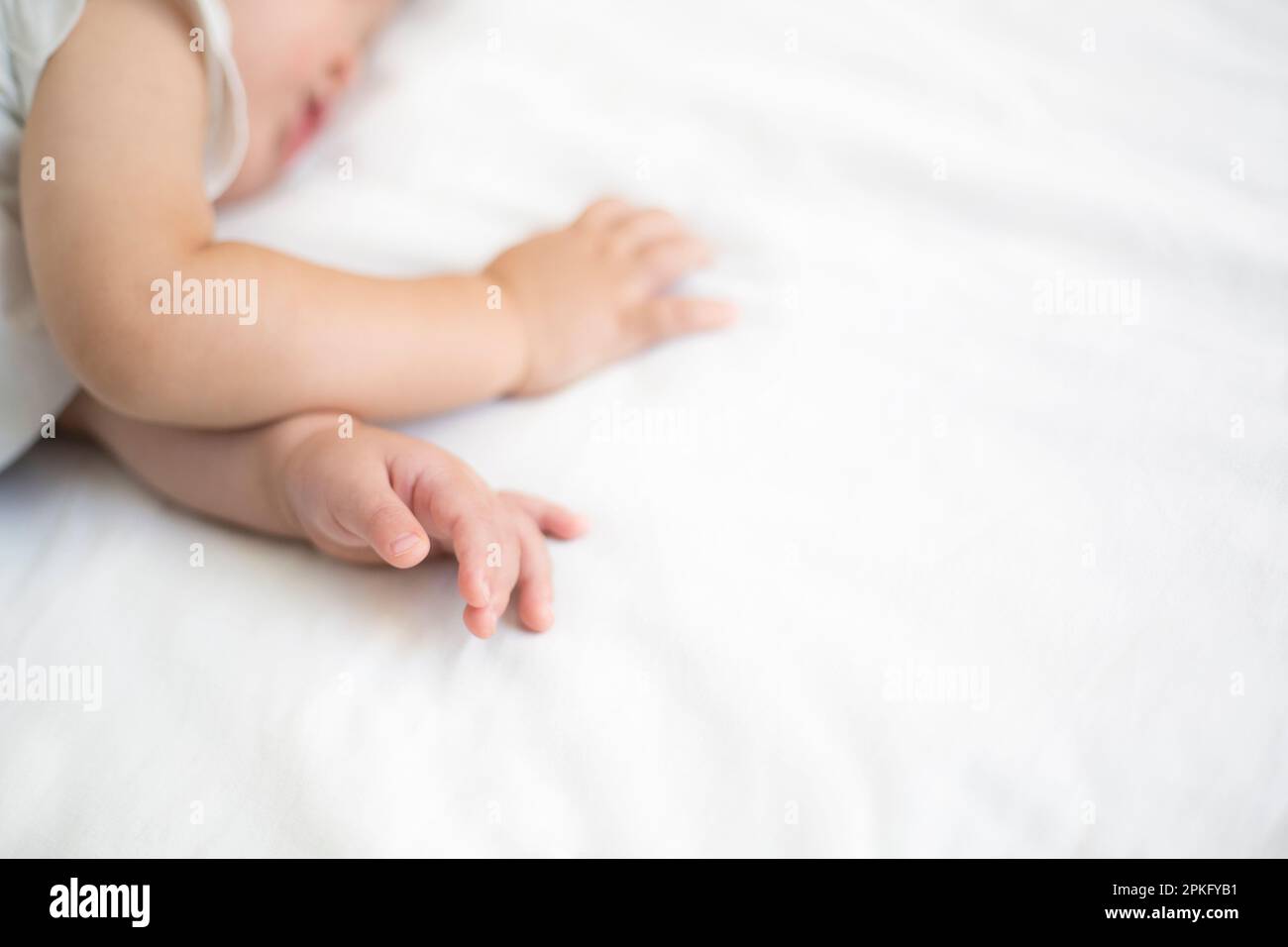 Napping baby's hands Stock Photo