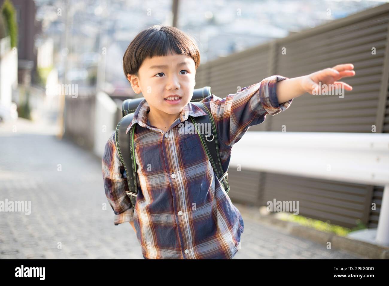 A boy walking with school bag on his back Stock Photo - Alamy