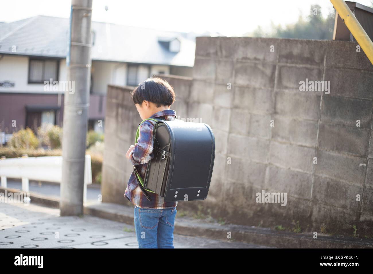 A boy walking with school bag on his back Stock Photo - Alamy