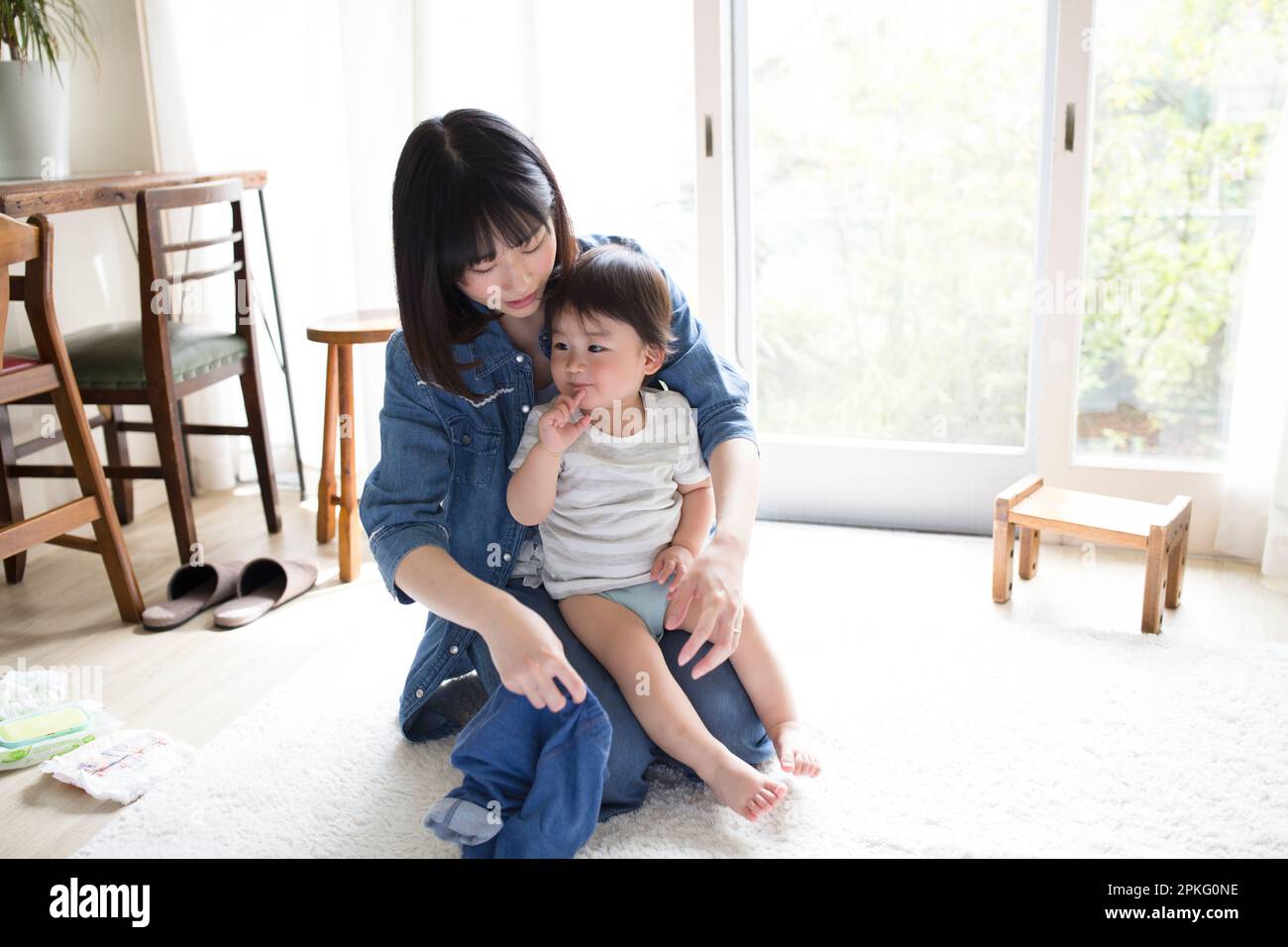A Mother Changing Her Child s Clothes Stock Photo Alamy a-mother-changing-her-child-s-clothes-stock-photo-alamy