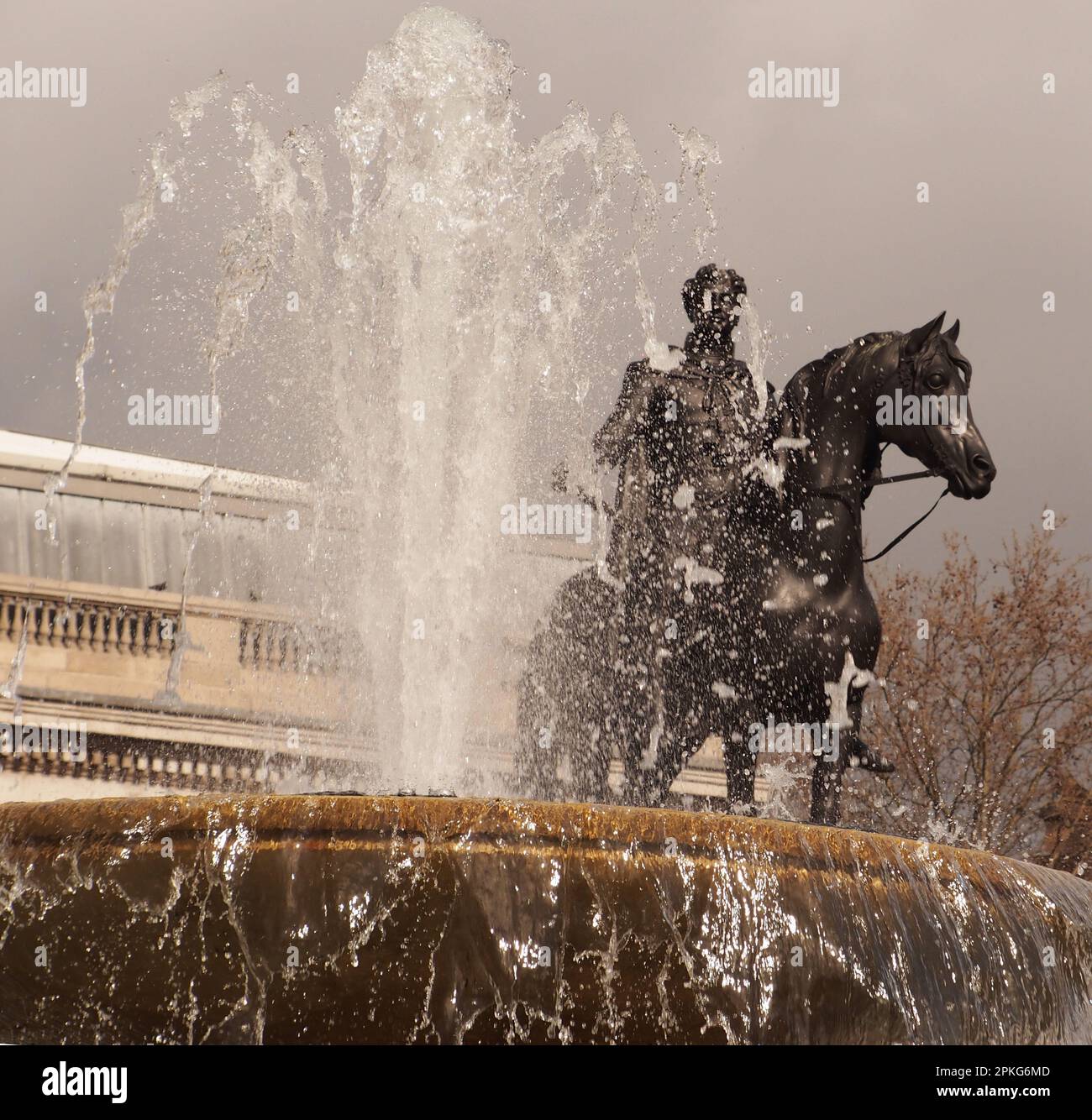 Equestrian statue of George IV in Trafalgar Square, London. UK behind one of the water fountains Stock Photo