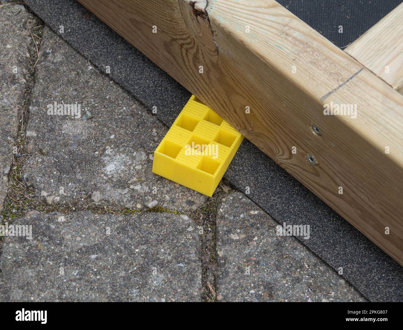Impregnated timber wooden board stabilized with wedge of hard plastic. Stock Photo