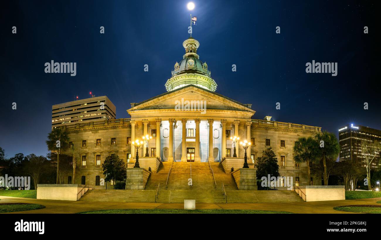 Illuminated South Carolina State House, in Columbia, SC, under a starry sky with a full moon. The South Carolina State House is the building housing t Stock Photo
