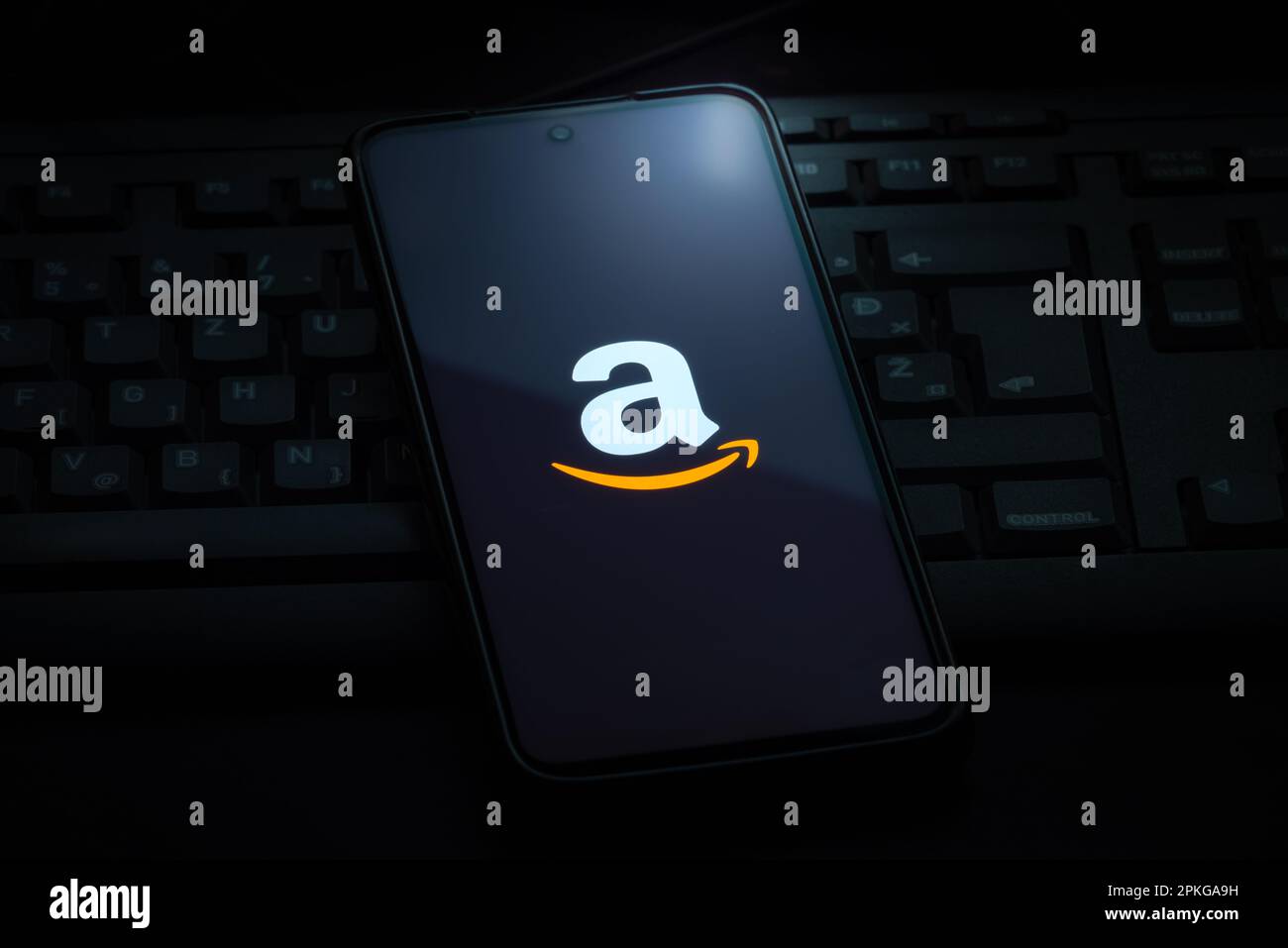 Ljubljana, Slovenia - 21 January 2023: Amazon logo on smartphone screen laying on computer keyboard Stock Photo