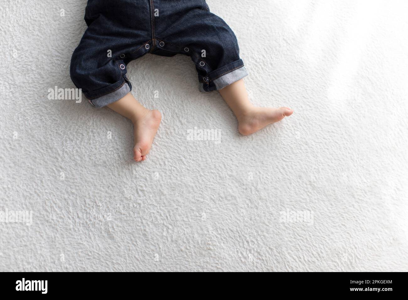 Baby feet sleeping in living room Stock Photo Alamy