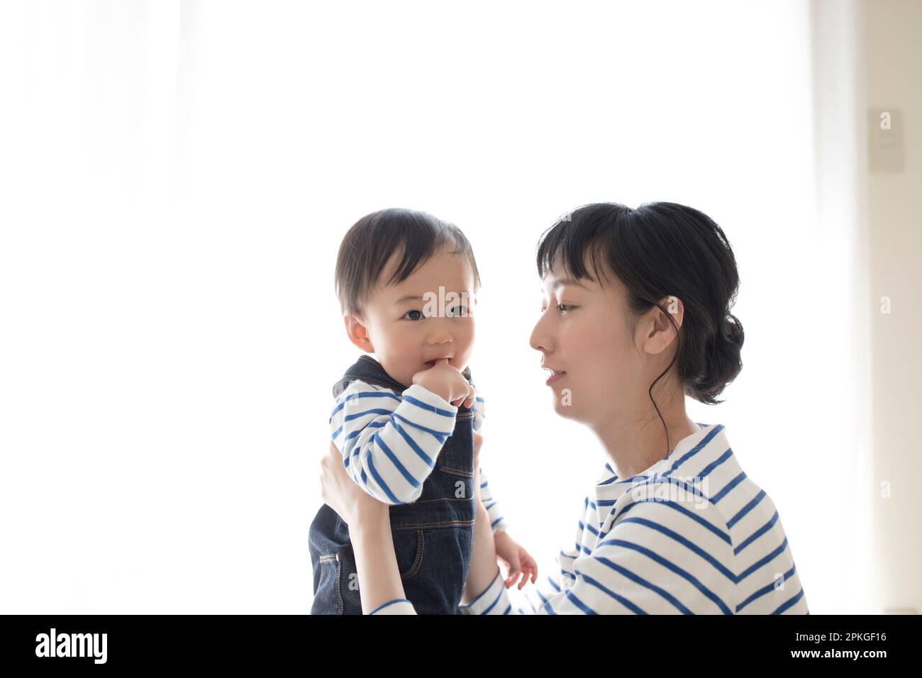 Baby being carried by mother Stock Photo Alamy