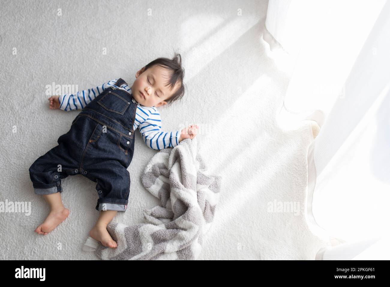 Baby taking a nap in the living room Stock Photo