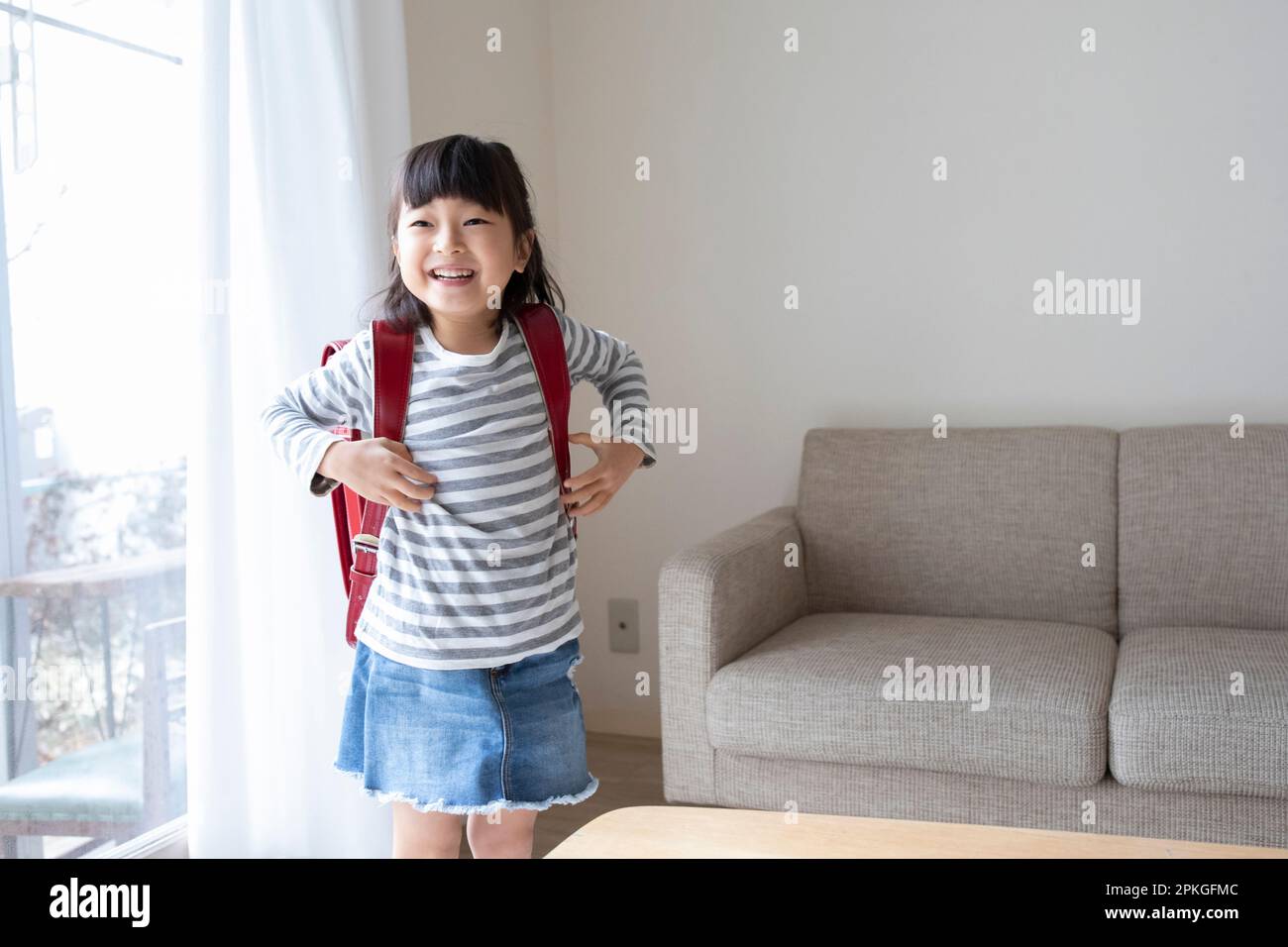 Girl carrying a school bag Stock Photo Alamy