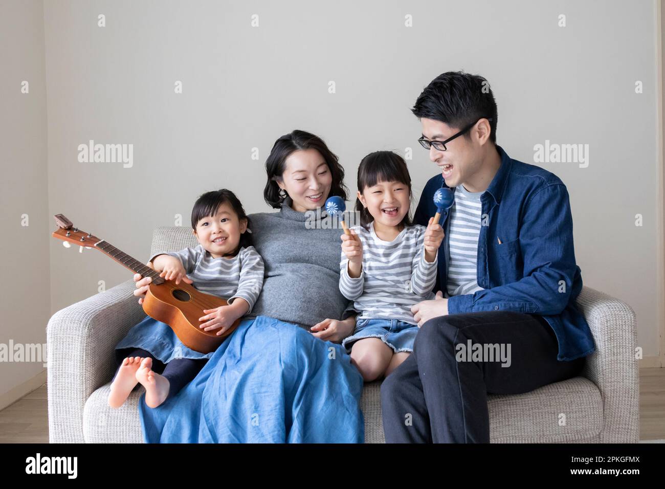 Family relaxing on the sofa Stock Photo