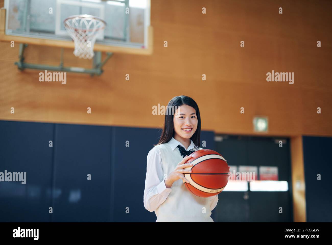 High school girl with a basketball in the gym Stock Photo