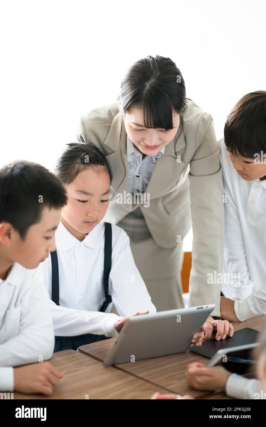 An Elementary School Student Teaching Programming to a Teacher AR Stock ...