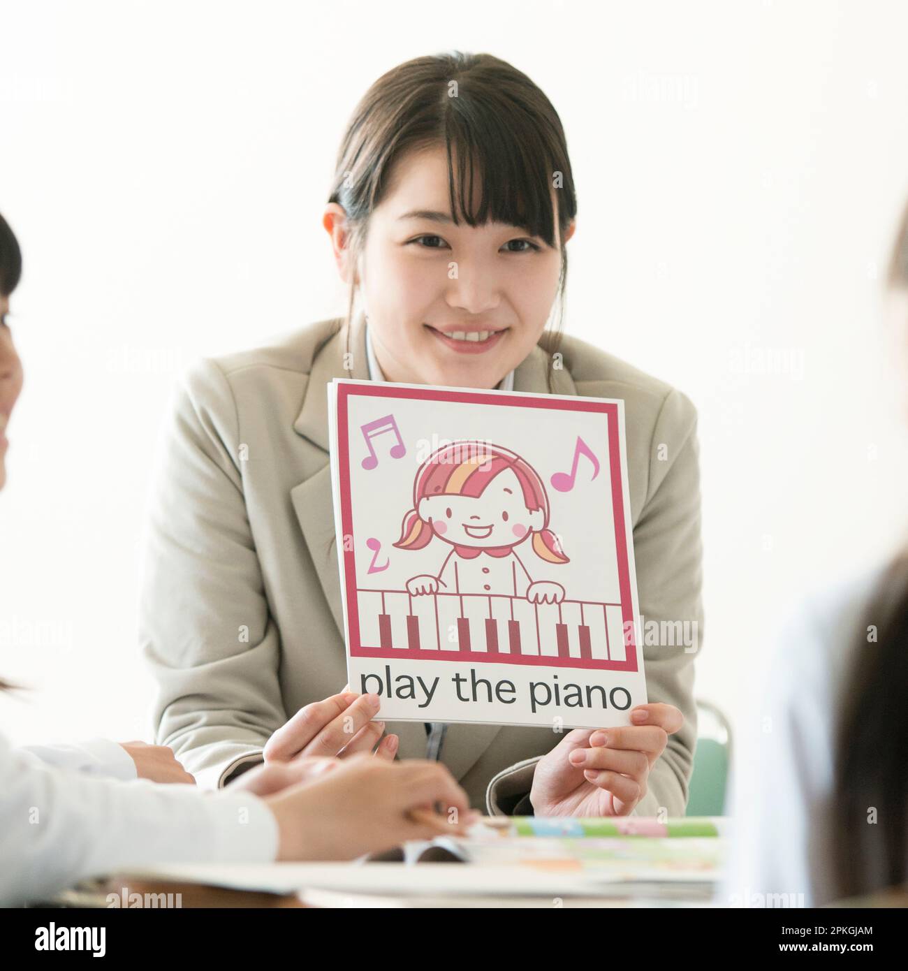 Teacher teaches English to elementary school students Stock Photo