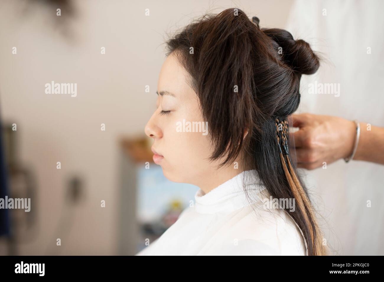 Woman getting hair extensions Stock Photo
