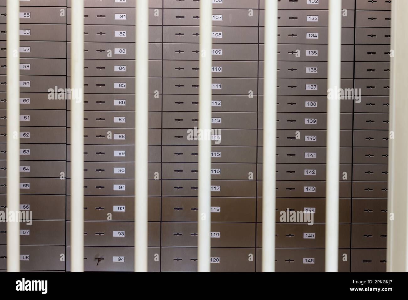 safe deposit boxes in a bank behind bars Stock Photo