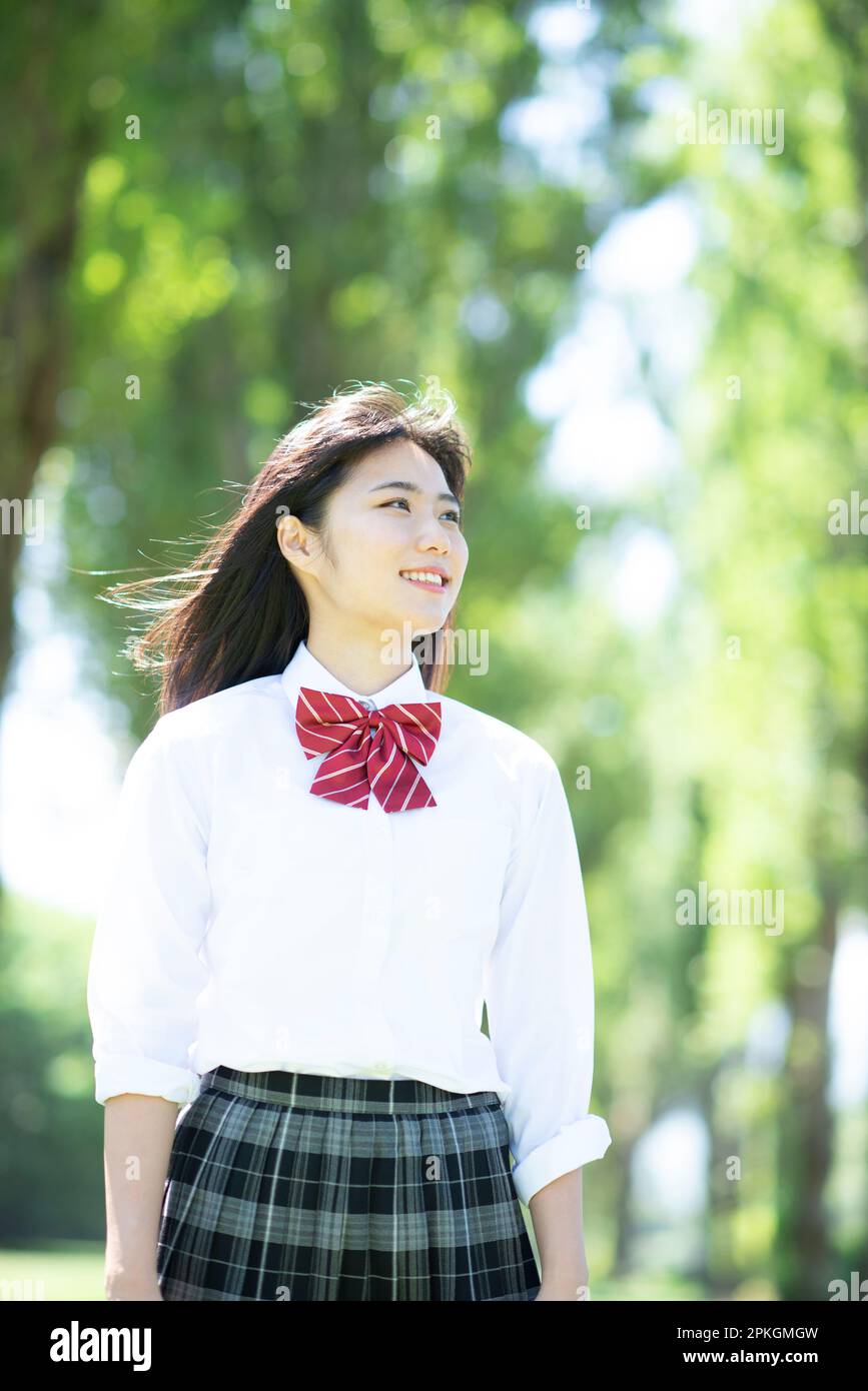 Female student smiling at a row of poplar trees Stock Photo - Alamy