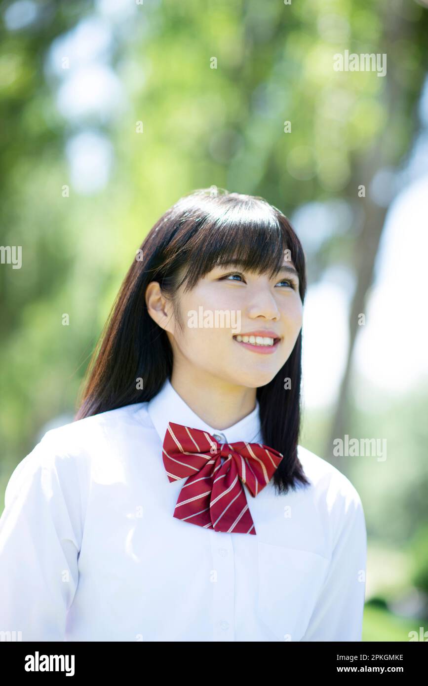 Female student smiling at a row of poplar trees Stock Photo - Alamy