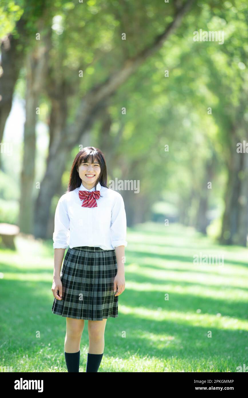 Female student smiling at a row of poplar trees Stock Photo - Alamy