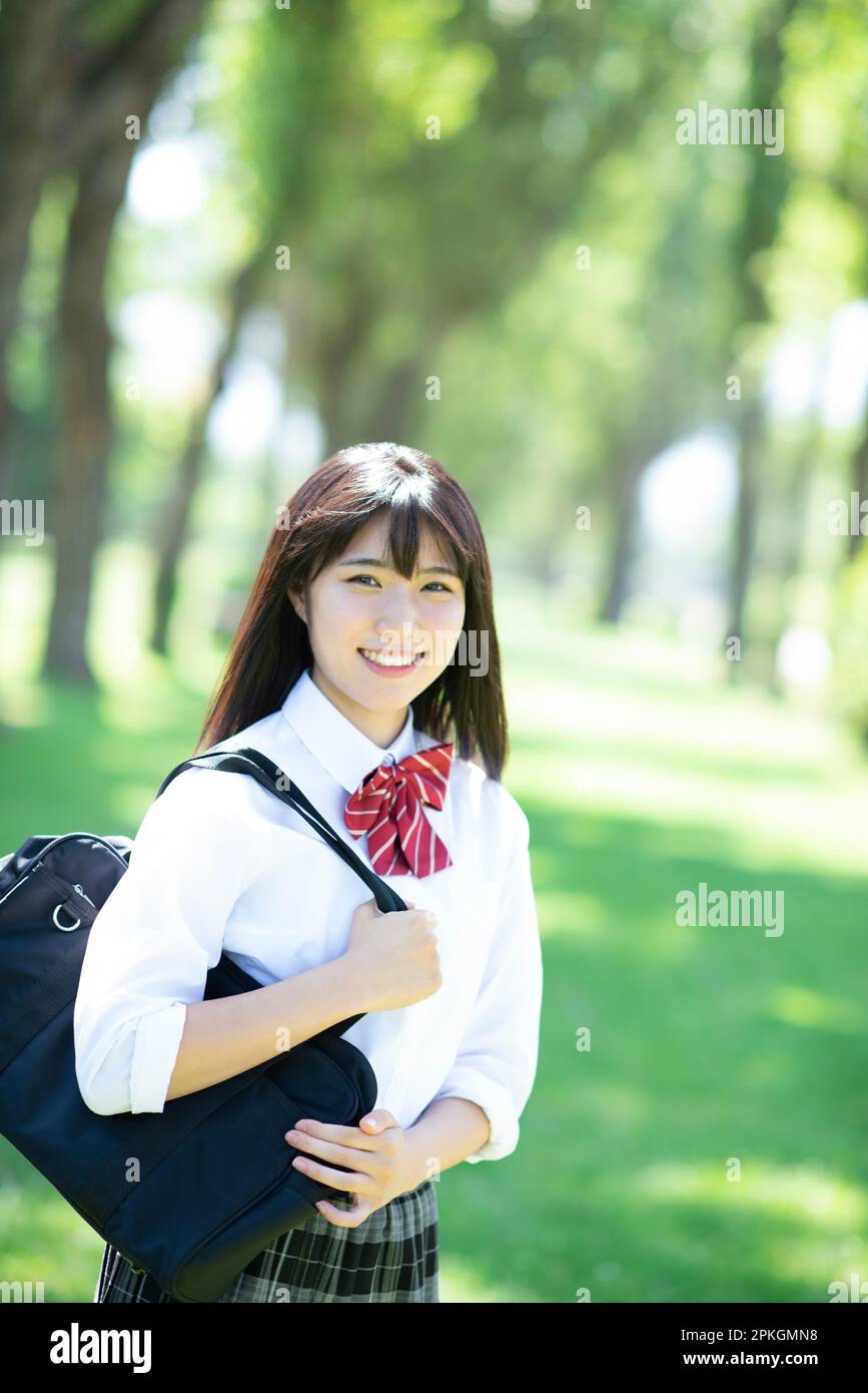 Female student smiling at a row of poplar trees Stock Photo - Alamy