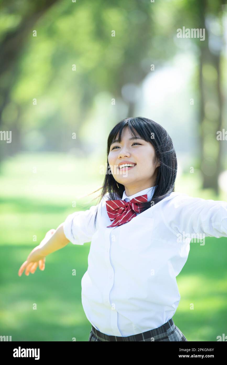 Female student spreading her hands on a row of poplar trees Stock Photo ...