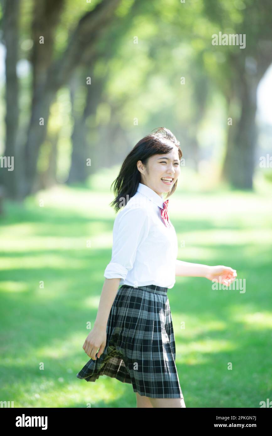 Female student running along a row of poplar trees Stock Photo - Alamy
