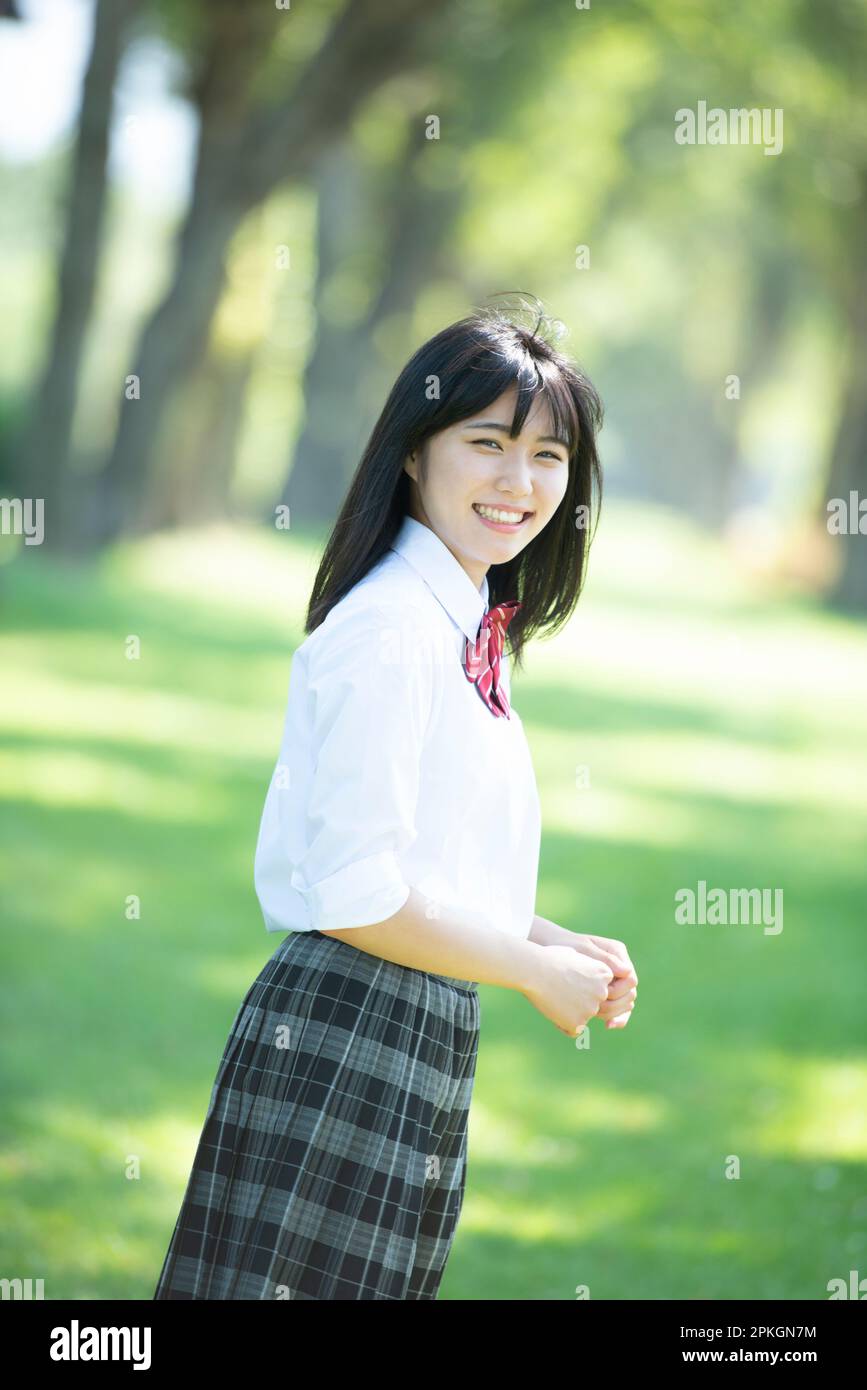 Female student smiling at a row of poplar trees Stock Photo - Alamy