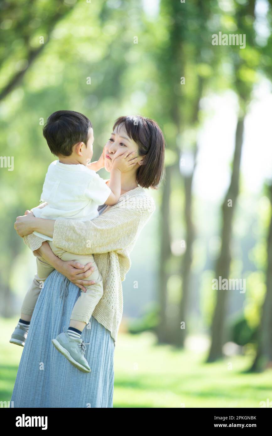 Mother and child face to face at a poplar tree lined with poplar trees Stock Photo