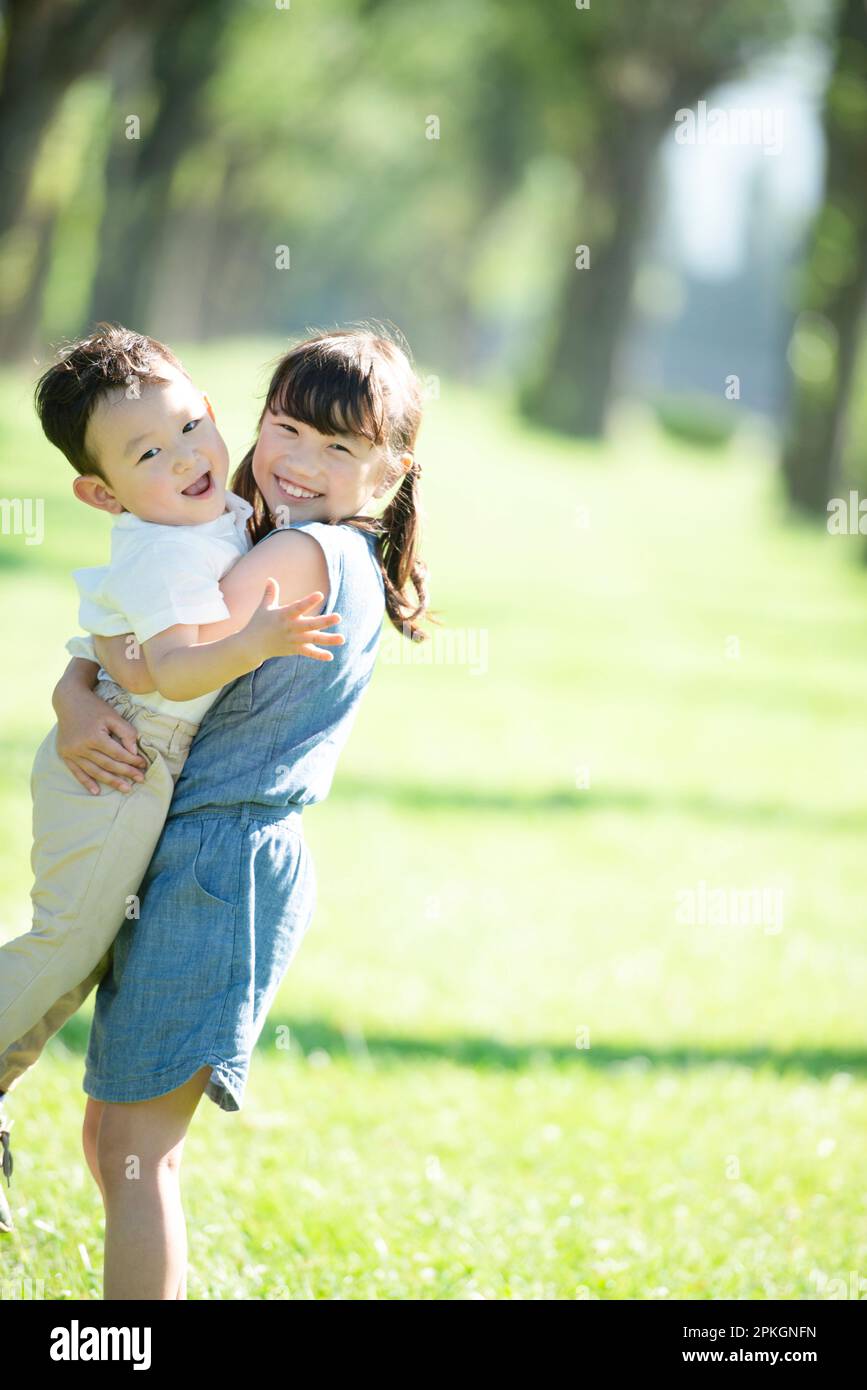 A sister and brother hugging each other in a row of poplar trees Stock ...