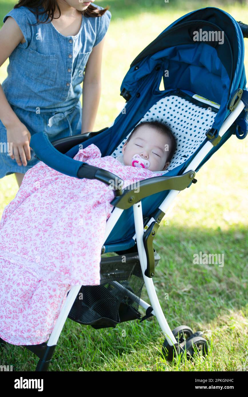 Baby sleeping in a stroller Stock Photo Alamy