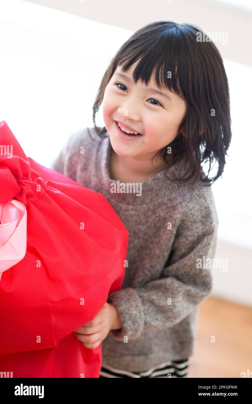 A girl smiling with a gift Stock Photo