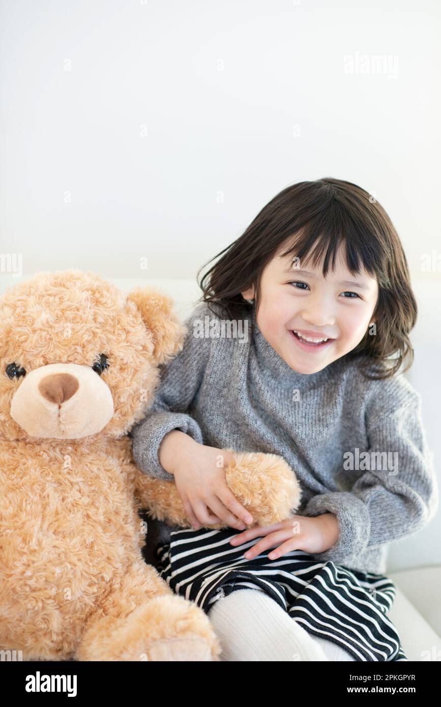 Girl with stuffed bear Stock Photo
