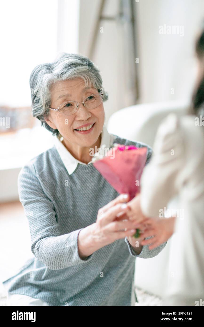 Grandmother receiving flowers from grandchildren Stock Photo Alamy