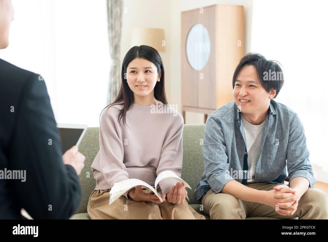 A couple talking with a businessman Stock Photo