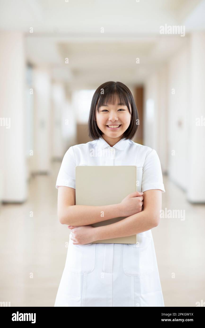 A smiling nursing student holding a file Stock Photo