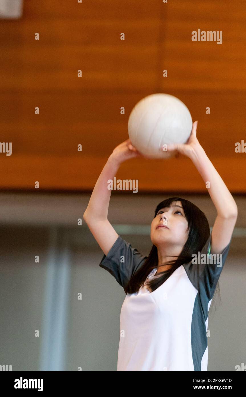 Female students playing volleyball in the gym Stock Photo Alamy
