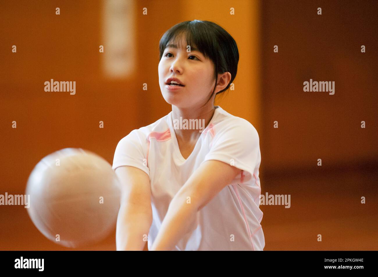 Female students playing volleyball in the gym Stock Photo Alamy