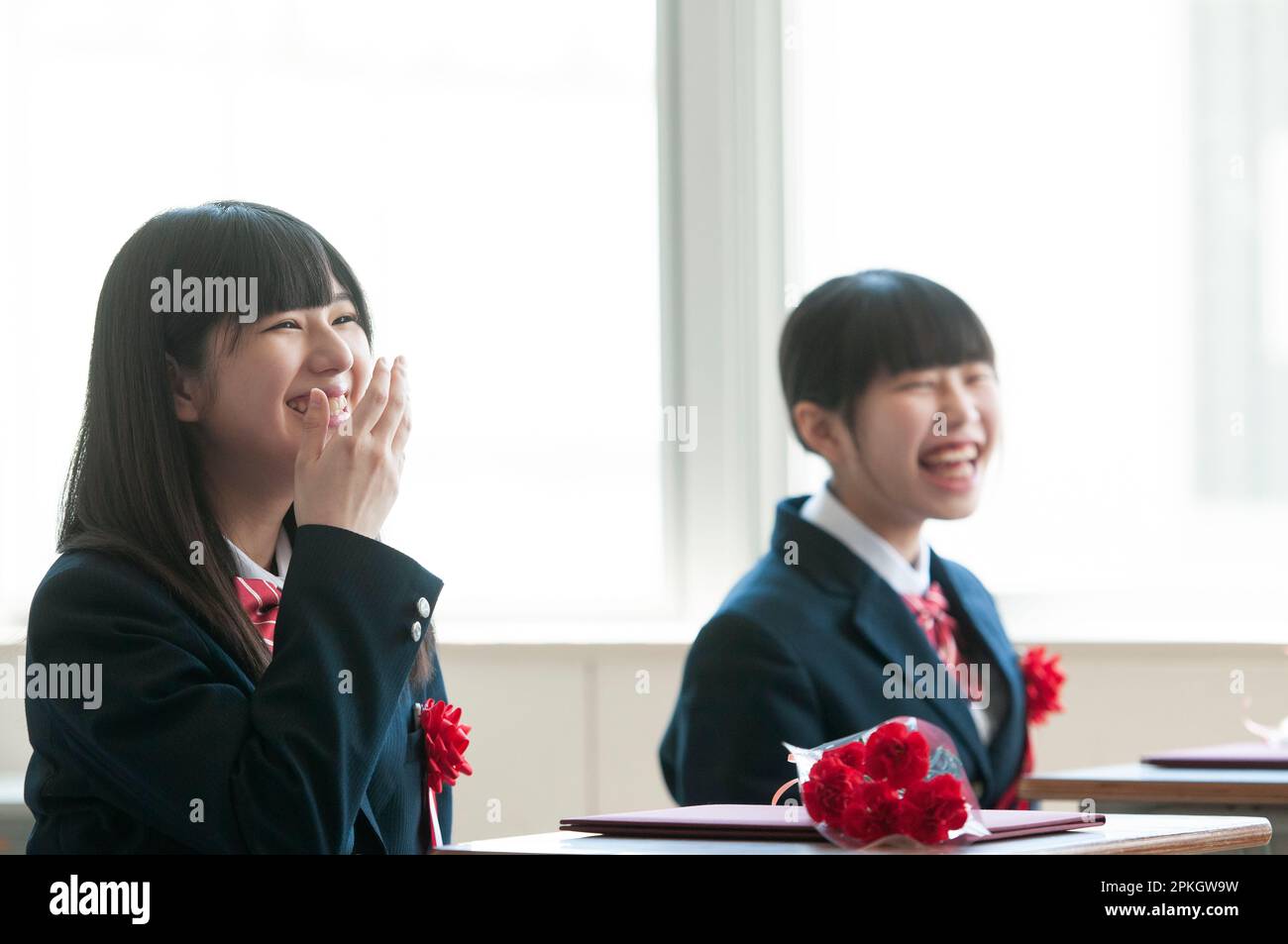 A female student smiling in a classroom Stock Photo - Alamy