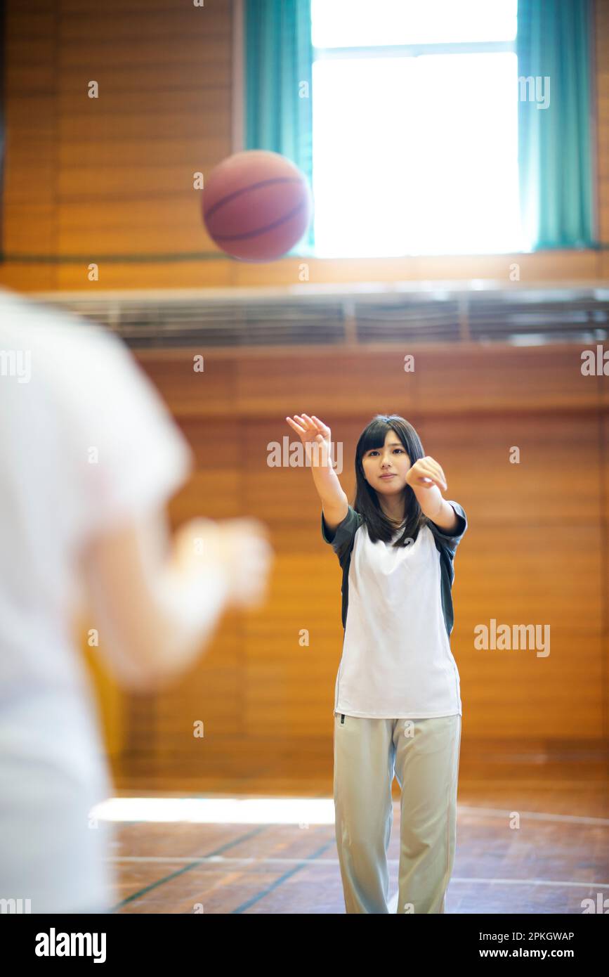 Female student playing basketball in the gym Stock Photo Alamy