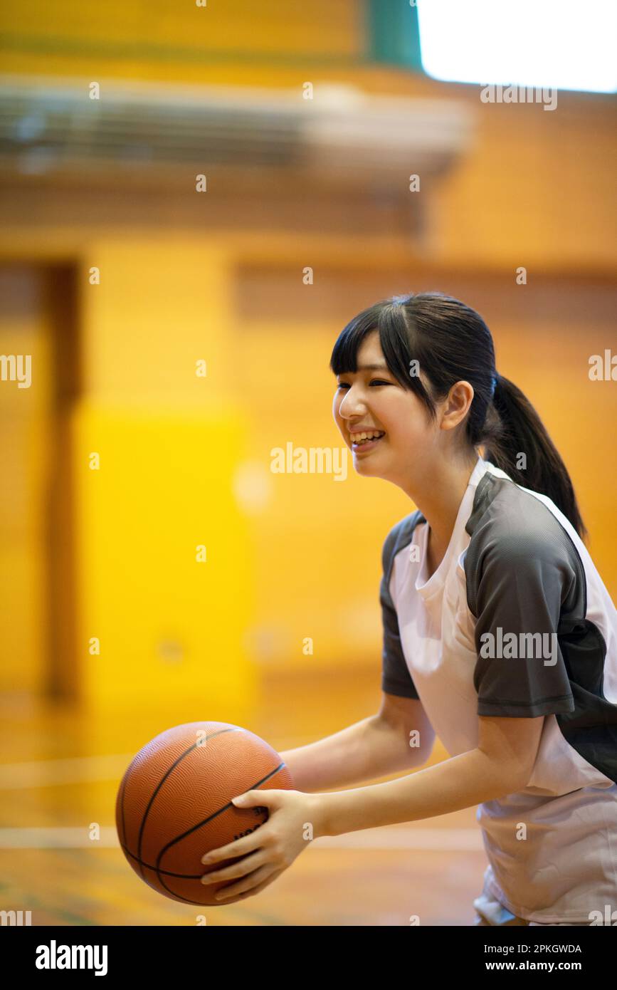 Female students playing basketball in the gym Stock Photo Alamy