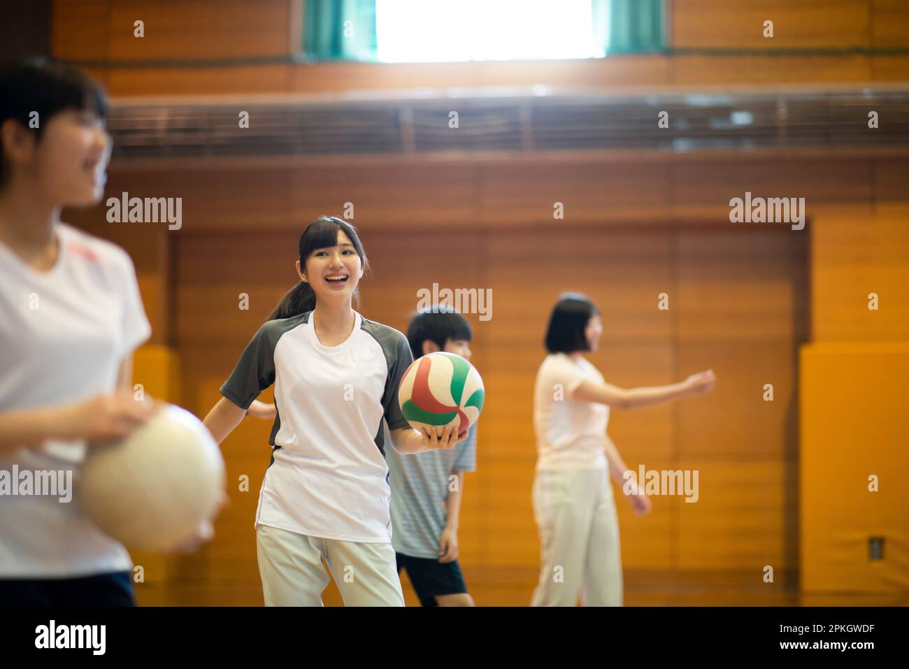 Students practicing volleyball in the gym Stock Photo Alamy