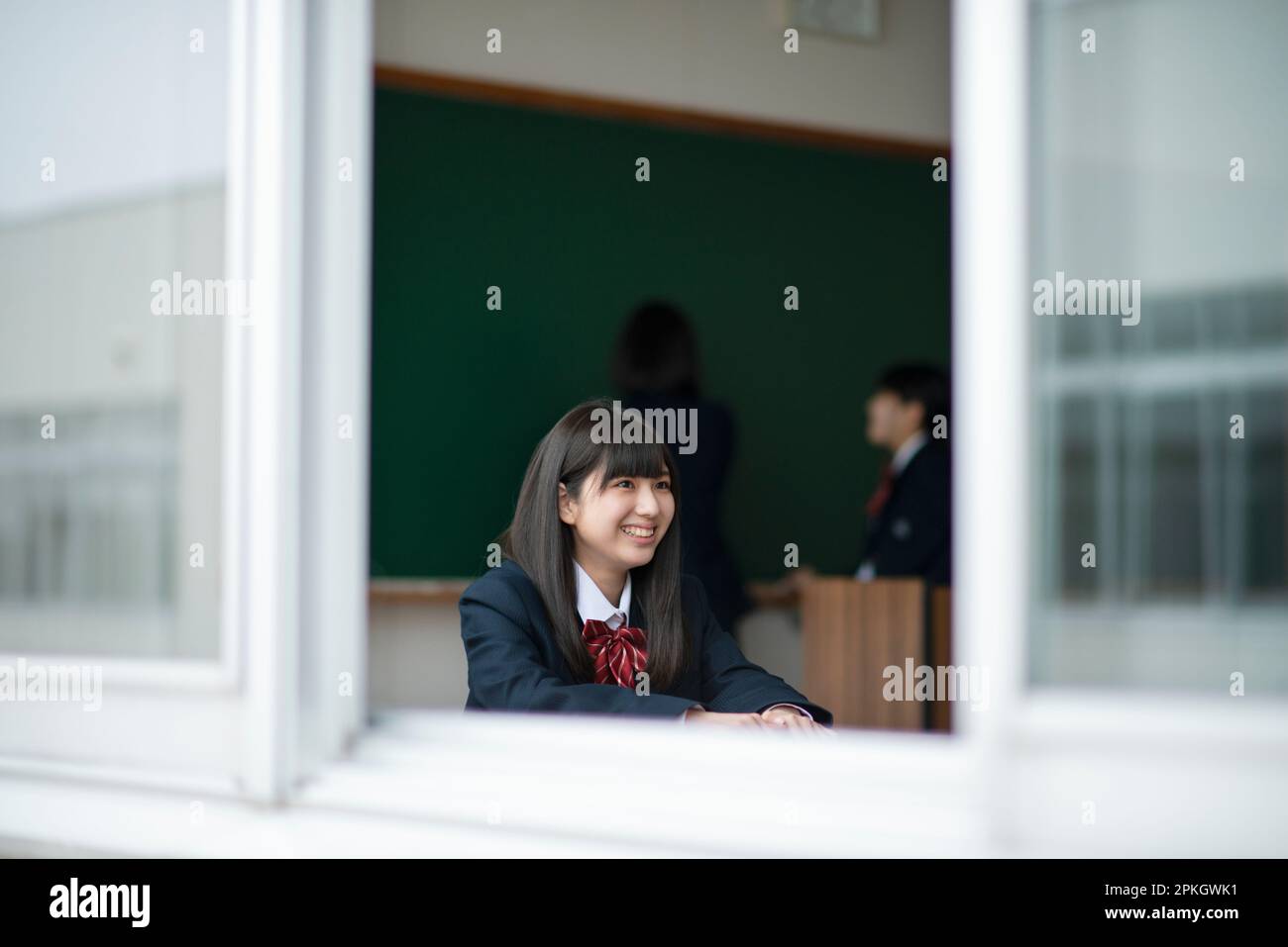 Female student smiling in the classroom Stock Photo - Alamy